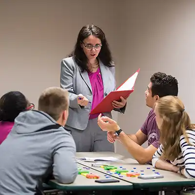 Professor providing practical healthcare instruction.
