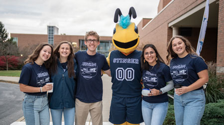 Students standing with Stinger