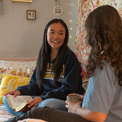 Roommates talking in room.