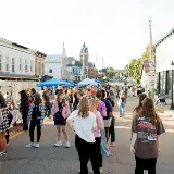 studentsandtownspeoplemillingarounddowntownduringSidewalkSaturdaysinCedarvilleOhio