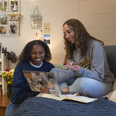 Females hanging out in a dorm room.