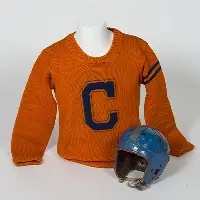 Orange sweater with letter C on front next to blue football helmet.