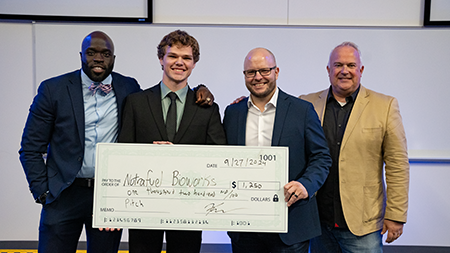 Daniel Ormsbee with the pitch judges and check