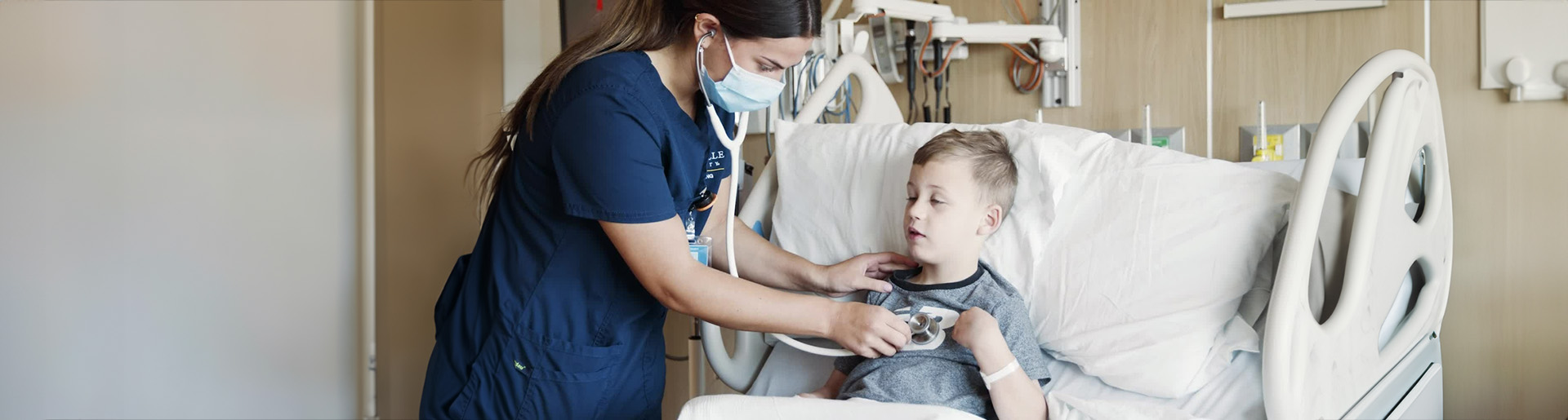 Cedarville University nurse treating a young patient.