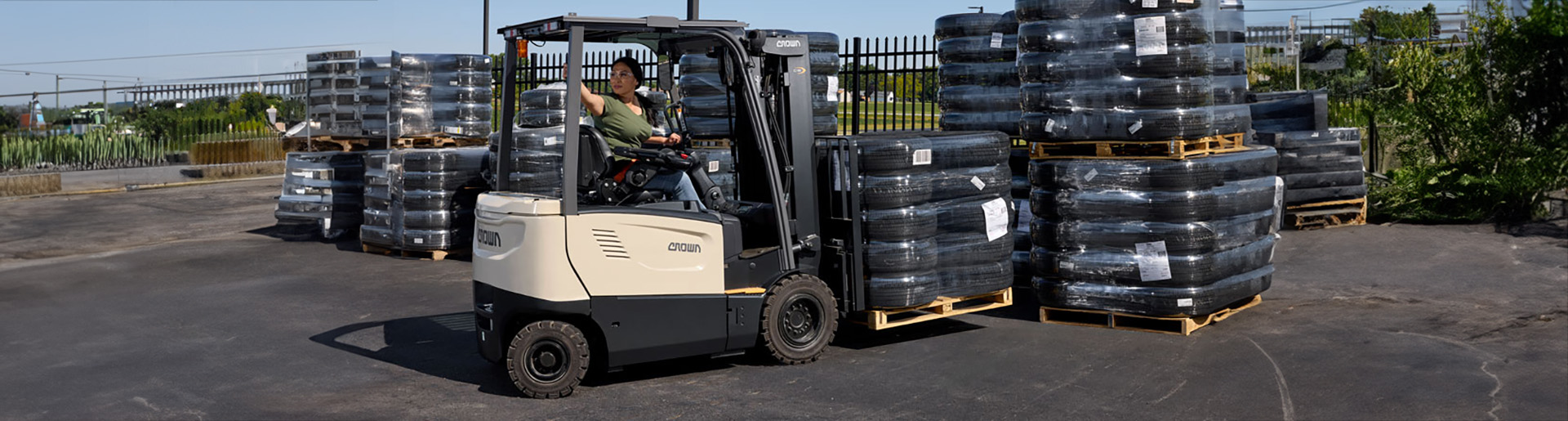 Crown fork lifting a pallet of tires.