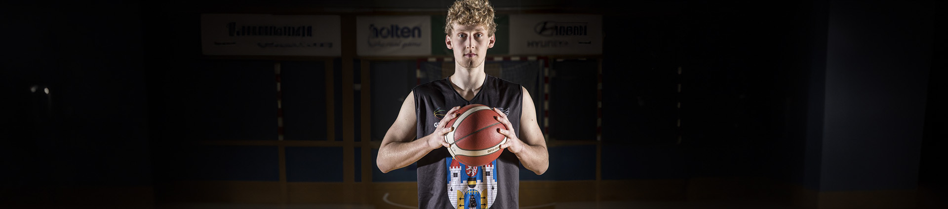 Ondrej Plasil holding a basketball on the court at Get Better Academy in Czech Republic.