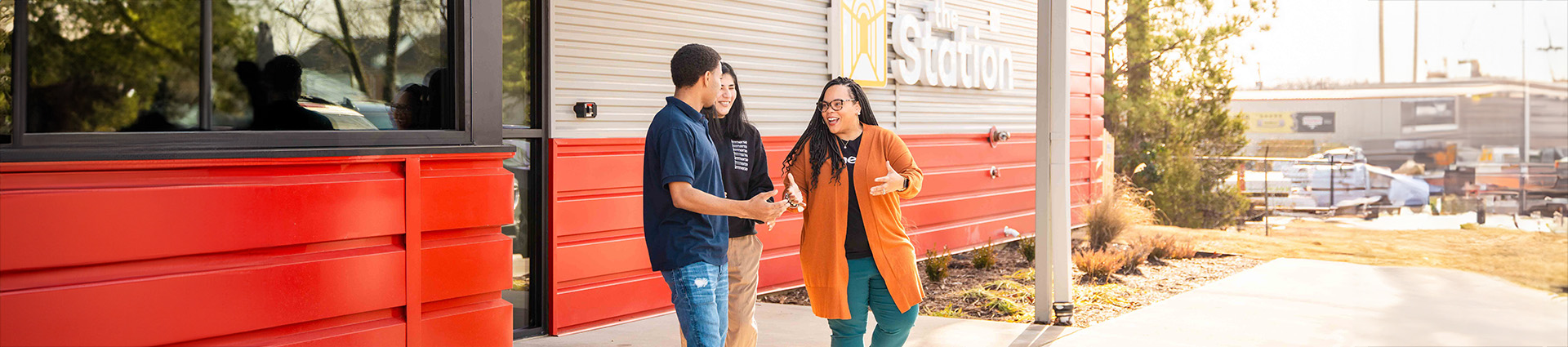 Female worker greets young man arriving at Immerse Arkansas' Station in Little Rock.