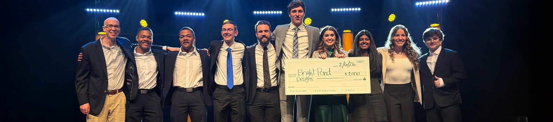 Dr. Kary Oberbrunner on the chapel stage with winners of the 2026 Pitch Competition.