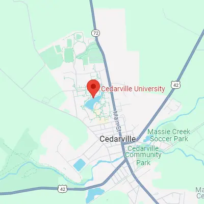 Male professor teaching class at a podium.