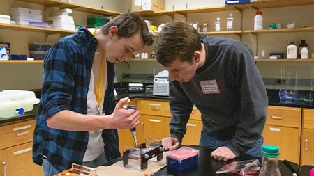 High school student with college student in biology lab
