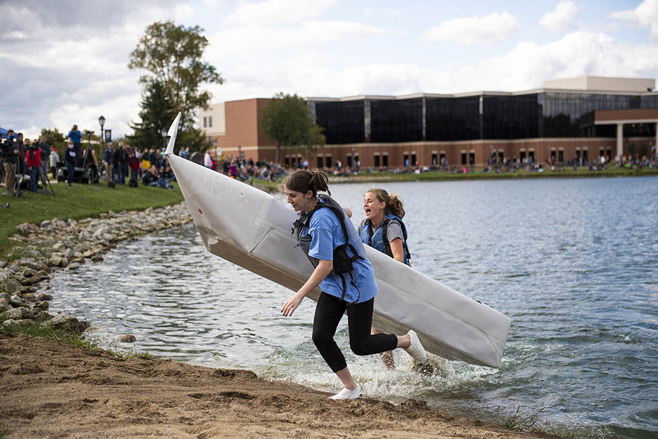 Canoe #28 attempts to make it to shore as spectators watch on.