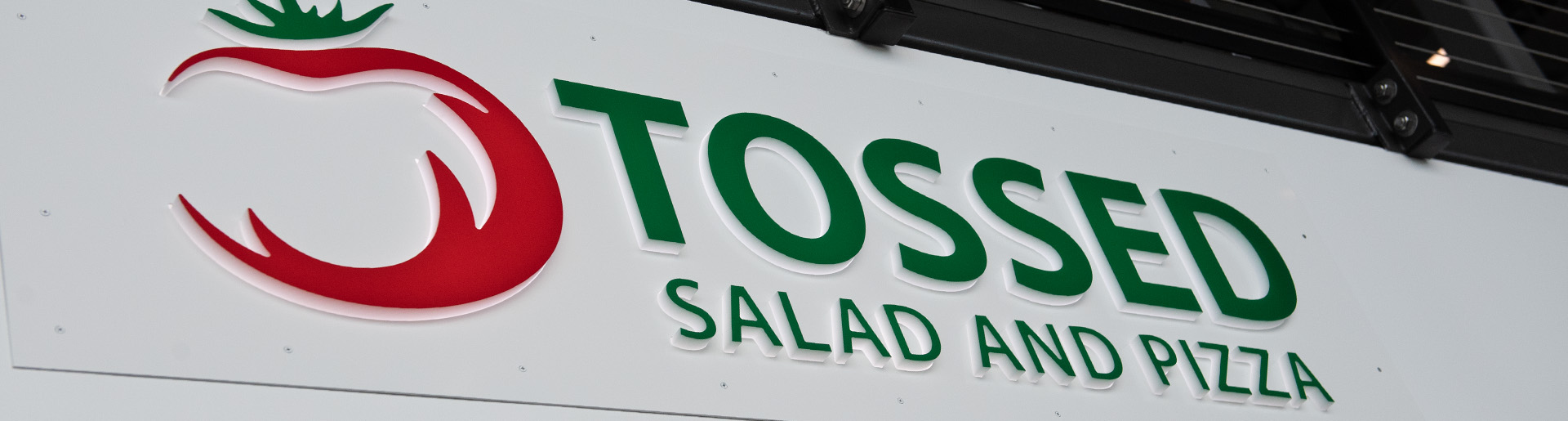 Sign that states Tossed, Salad and Pizza