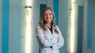 Female student posing in white pharmacy coat