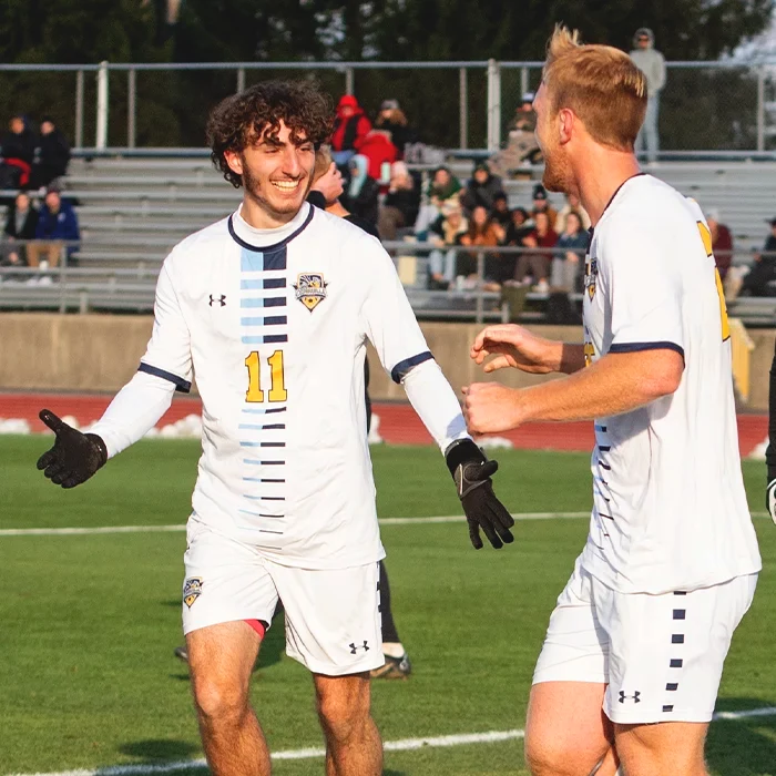 Students outdoors by the lake enjoying a beautiful sunny spring day.