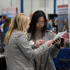 Two students looking at a job resume