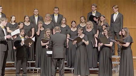Group of singers performing with songbooks