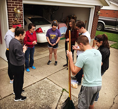 Students praying women after raking