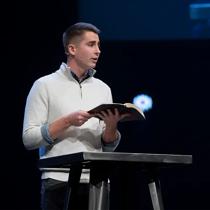 Man standing with book open