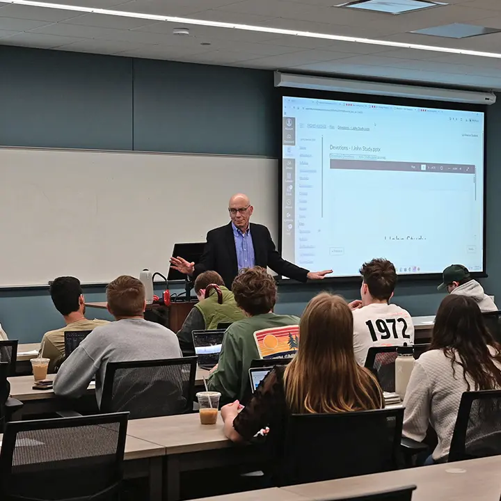 Professor teaching in front of students in class