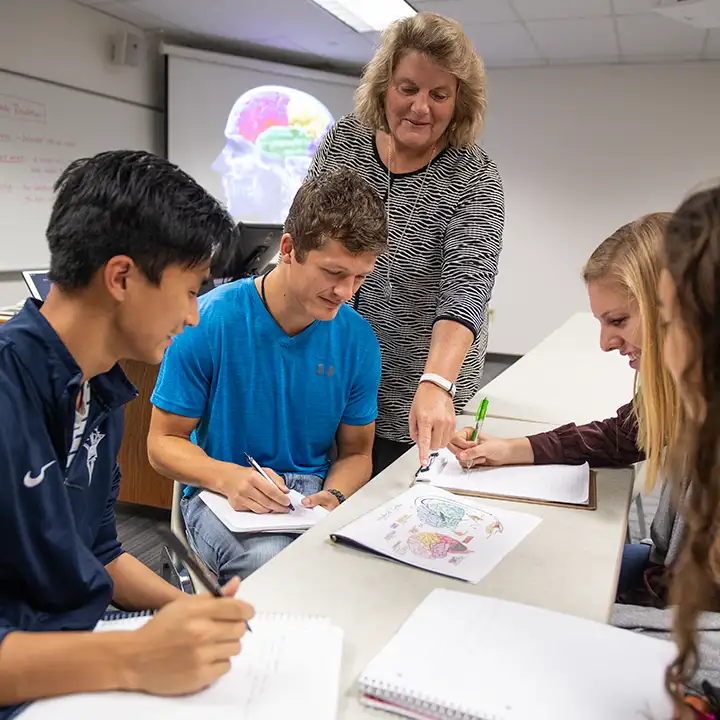 People working at a table with papers.