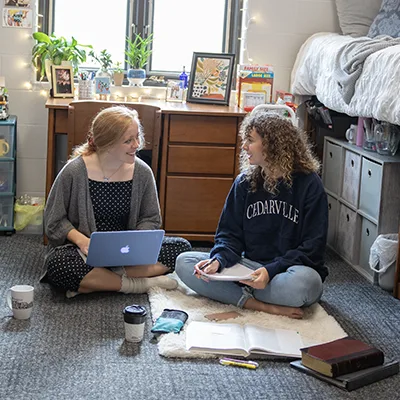 Roommates sitting on floor talking